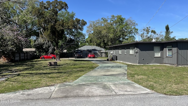 exterior space with a lawn and fence