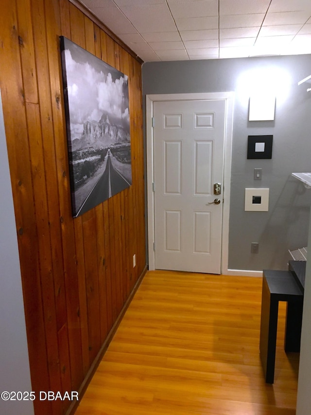 interior space featuring light wood finished floors and wooden walls