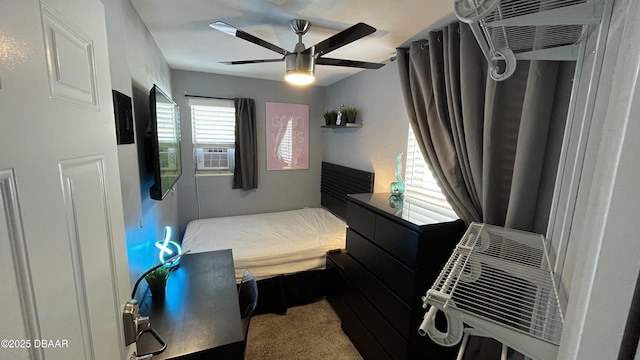 carpeted bedroom with cooling unit and a ceiling fan