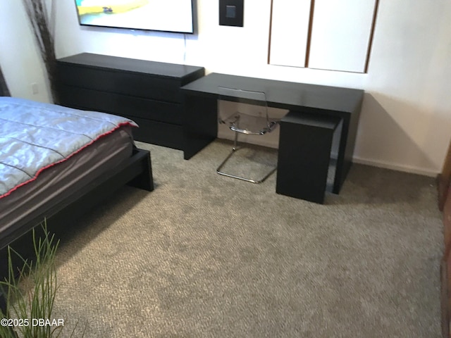 bedroom featuring baseboards, carpet, and built in desk