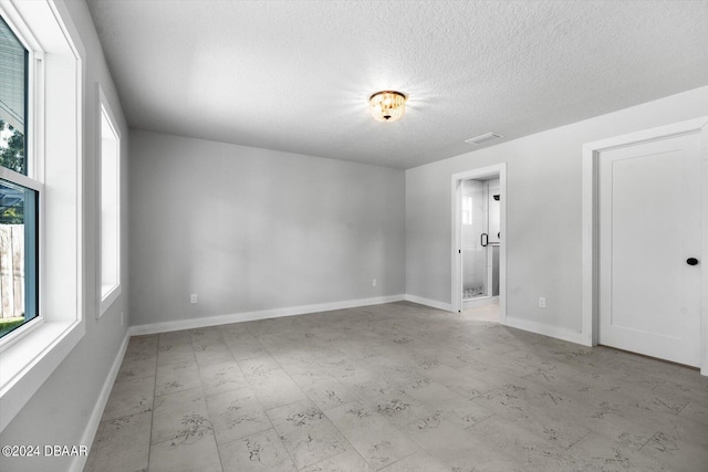 empty room featuring a textured ceiling