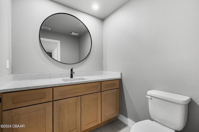 bathroom featuring toilet and vanity