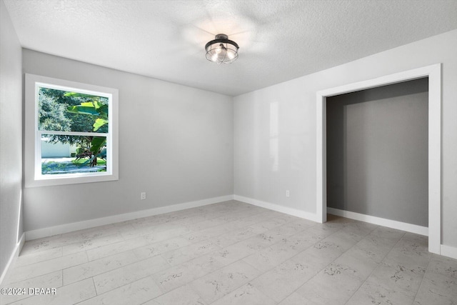 empty room featuring a textured ceiling