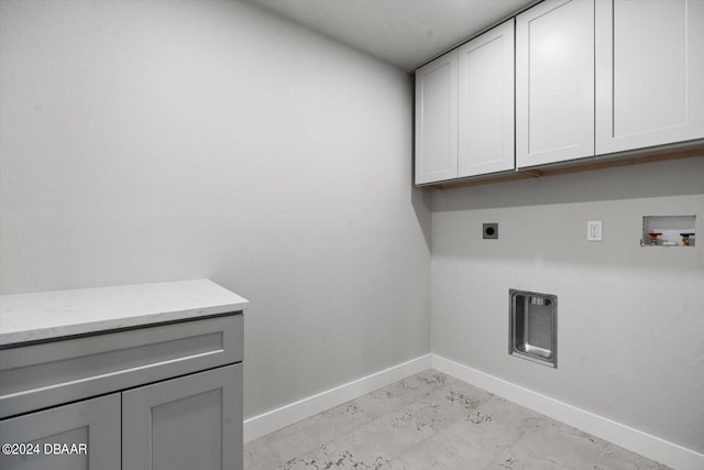 laundry area with cabinets, hookup for a washing machine, and hookup for an electric dryer