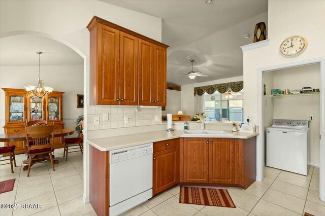 979 Leyburn Dr, Deltona, FL 32725 - kitchen with light tile patterned floors, washer / dryer, dishwasher, and a sink