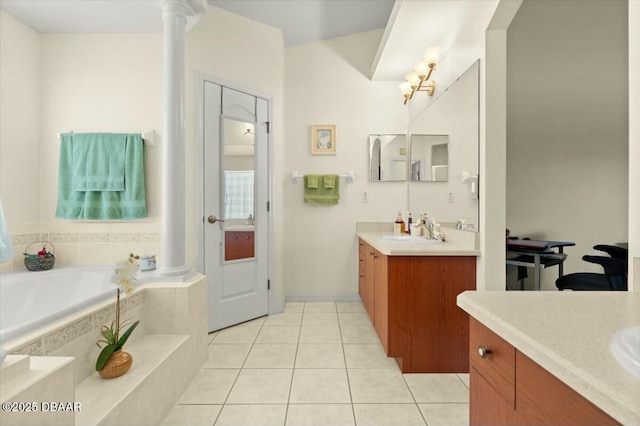 979 Leyburn Dr, Deltona, FL 32725 - bathroom featuring a sink, a bath, decorative columns, tile patterned floors, and two vanities