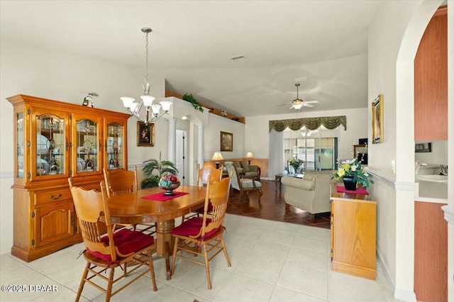 979 Leyburn Dr, Deltona, FL 32725 - dining room with light tile patterned floors, arched walkways, and ceiling fan with notable chandelier