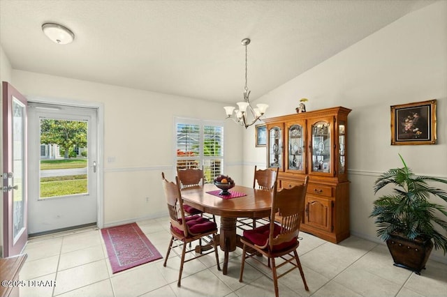 979 Leyburn Dr, Deltona, FL 32725 - dining space featuring light tile patterned floors, lofted ceiling, a chandelier, and baseboards