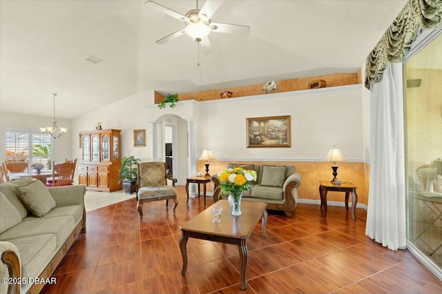 979 Leyburn Dr, Deltona, FL 32725 - living room featuring wood finished floors, vaulted ceiling, and ceiling fan with notable chandelier
