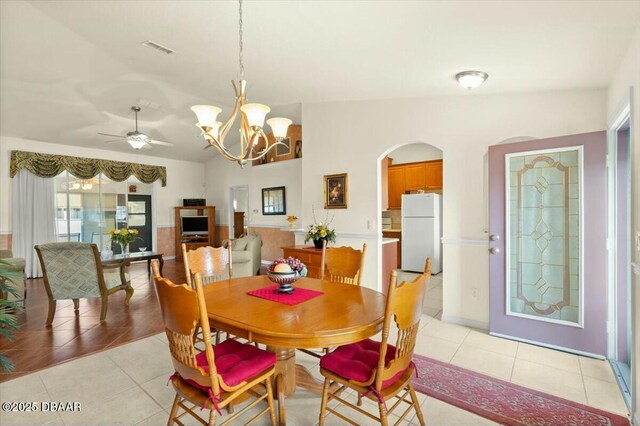 979 Leyburn Dr, Deltona, FL 32725 - dining area with light tile patterned floors, visible vents, ceiling fan with notable chandelier, and arched walkways