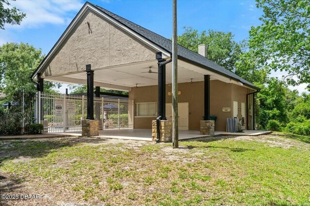 979 Leyburn Dr, Deltona, FL 32725 - back of house with stucco siding, fence, a chimney, and a patio