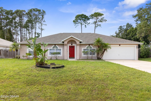 single story home featuring a garage and a front lawn