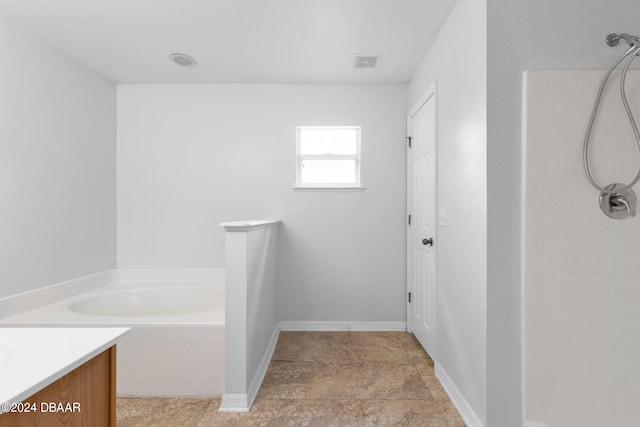 bathroom featuring plus walk in shower and vanity