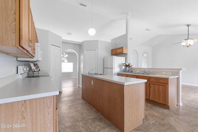 kitchen featuring a kitchen island, white appliances, sink, and lofted ceiling