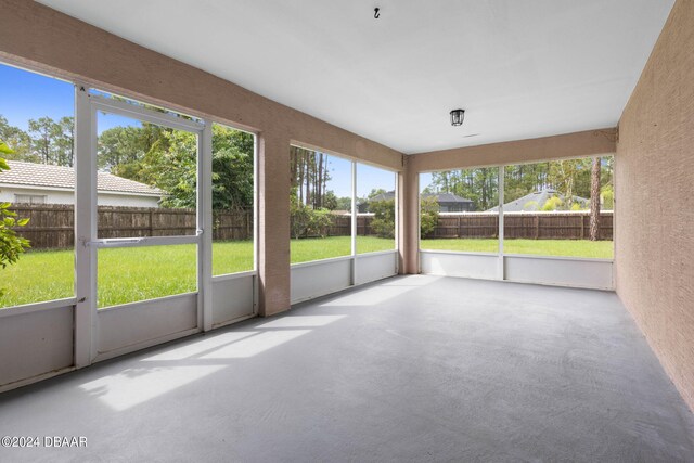 rear view of property featuring a lawn and a sunroom