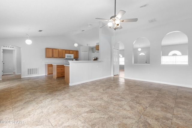 unfurnished living room featuring vaulted ceiling and ceiling fan