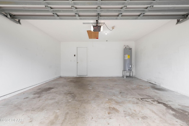 garage with a garage door opener and electric water heater