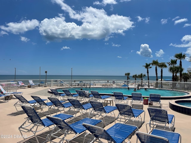 view of swimming pool with a water view