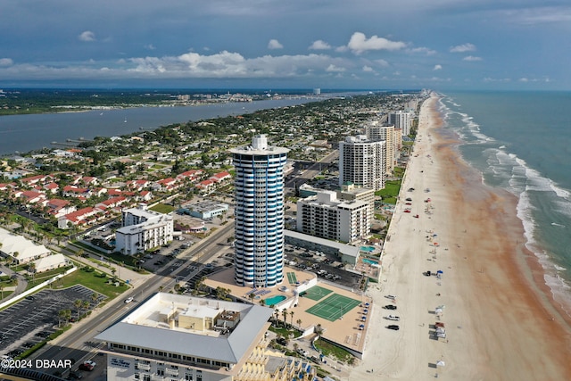 birds eye view of property featuring a water view and a beach view