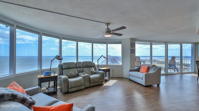 interior space featuring ceiling fan and a water view