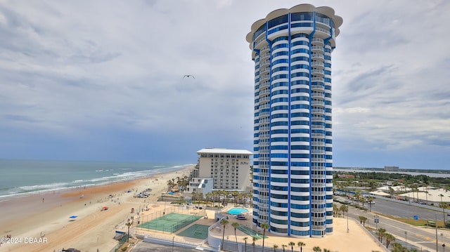 birds eye view of property with a beach view and a water view