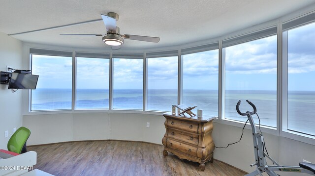 interior space featuring a water view and ceiling fan