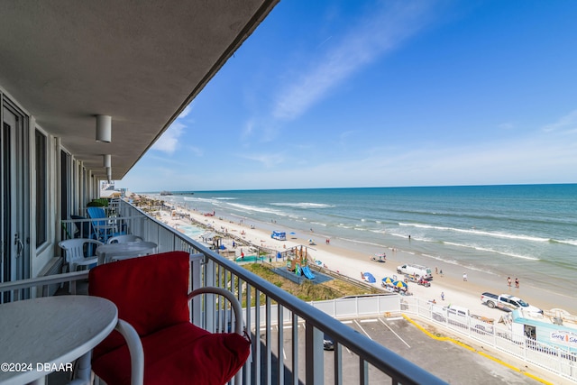 balcony featuring a beach view and a water view