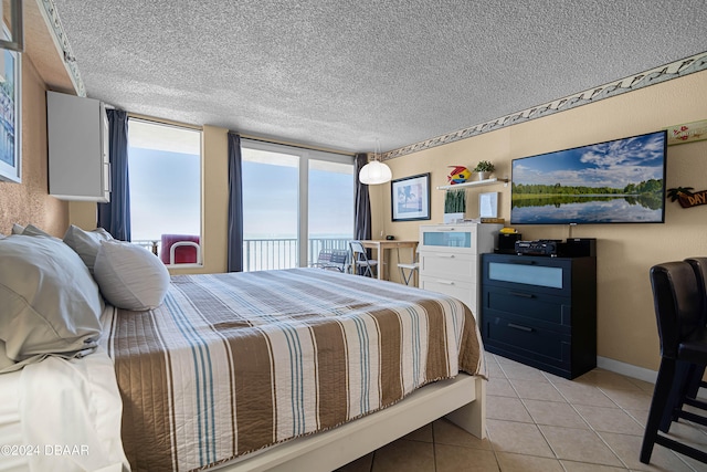 tiled bedroom with access to outside and a textured ceiling