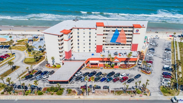 birds eye view of property featuring a beach view and a water view