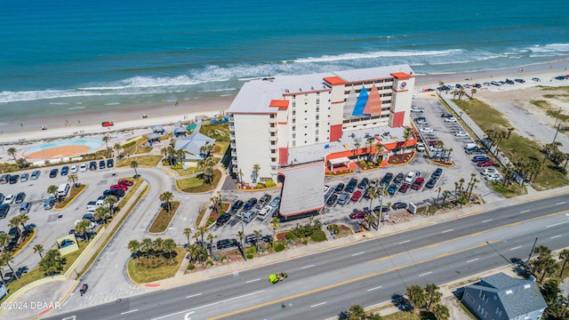 drone / aerial view featuring a water view and a beach view