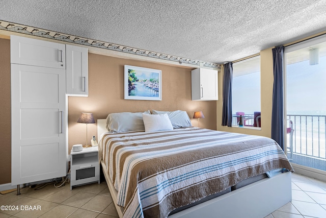 tiled bedroom with a textured ceiling