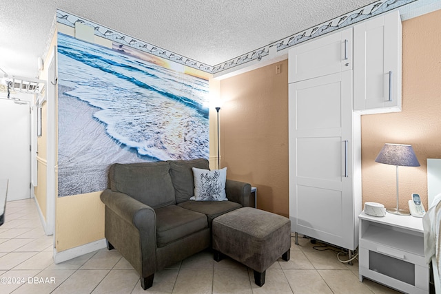 living area featuring a textured ceiling and light tile patterned floors