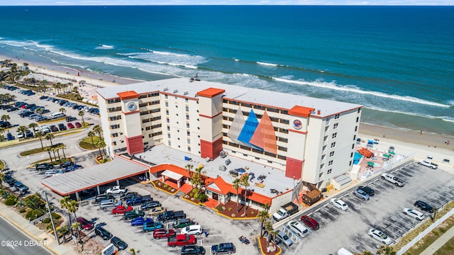 birds eye view of property with a view of the beach and a water view