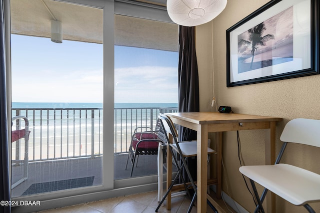 interior space featuring a view of the beach and a water view