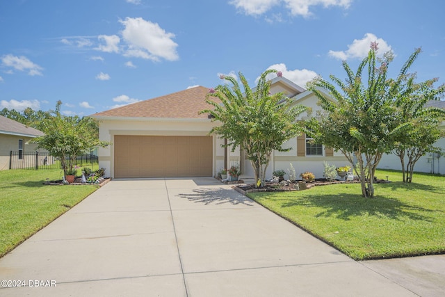 view of front of property featuring a front lawn and a garage