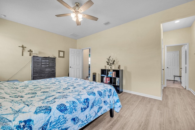 bedroom with ceiling fan and light hardwood / wood-style flooring