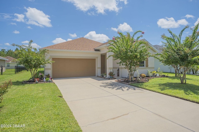 view of front of property featuring a garage and a front lawn