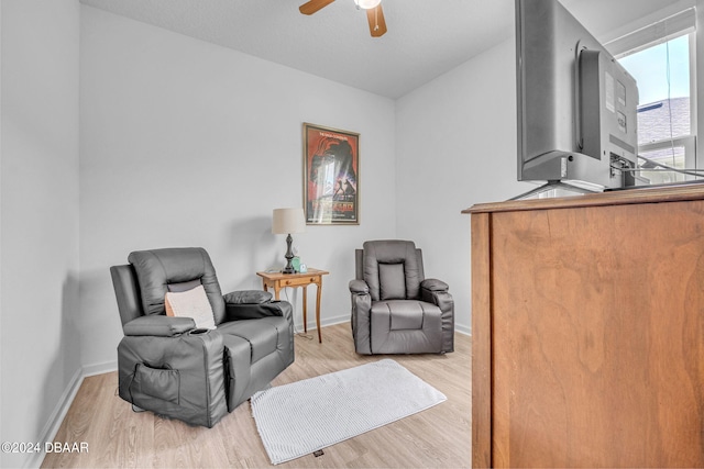 sitting room with light wood-type flooring and ceiling fan