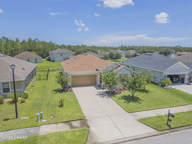 view of front of house with a front yard and a garage