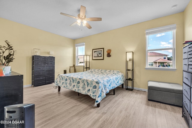 bedroom with light hardwood / wood-style floors and ceiling fan