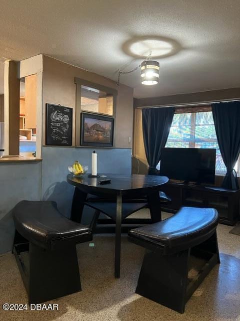 dining space with a textured ceiling