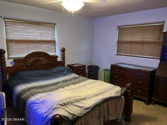 bedroom featuring ceiling fan and carpet flooring