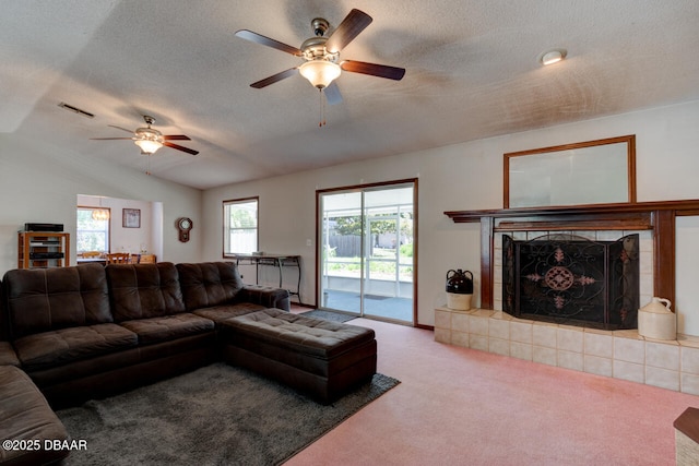 3119 Mango Tree Dr, Edgewater, FL 32141 - carpeted living area with a ceiling fan, a tiled fireplace, and a textured ceiling