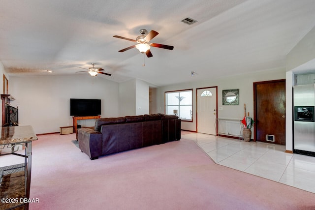 3119 Mango Tree Dr, Edgewater, FL 32141 - living room with a ceiling fan, light carpet, baseboards, lofted ceiling, and light tile patterned floors