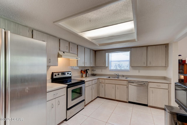 3119 Mango Tree Dr, Edgewater, FL 32141 - kitchen with appliances with stainless steel finishes, under cabinet range hood, a sink, light countertops, and a textured ceiling