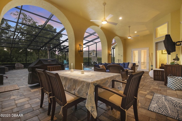1207 Kaleen Dr, Ormond Beach, FL 32174 - patio terrace at dusk featuring french doors, a patio, glass enclosure, and exterior bar