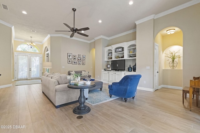 1207 Kaleen Dr, Ormond Beach, FL 32174 - living room featuring arched walkways, ornamental molding, light wood-style floors, a ceiling fan, and french doors