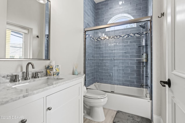 1207 Kaleen Dr, Ormond Beach, FL 32174 - full bath with vanity, combined bath / shower with glass door, and wood finished floors