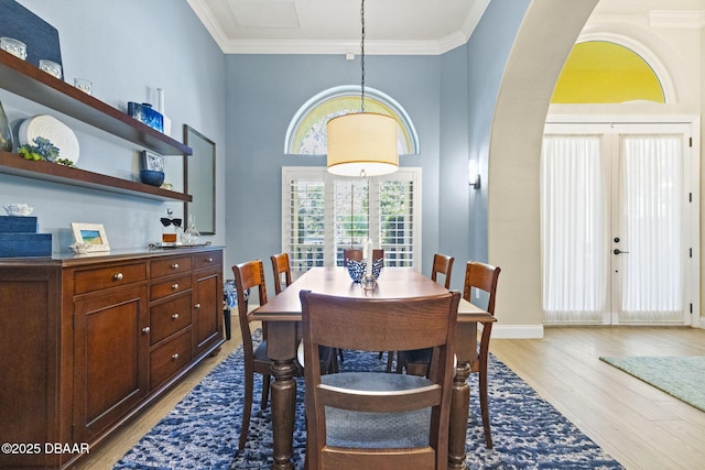 1207 Kaleen Dr, Ormond Beach, FL 32174 - dining room with light wood-type flooring, crown molding, arched walkways, and a high ceiling