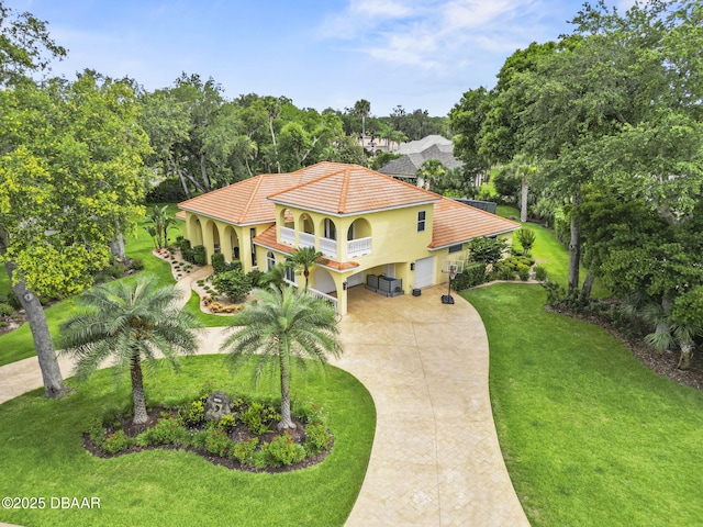 1207 Kaleen Dr, Ormond Beach, FL 32174 - view of front of house with driveway, a front lawn, a balcony, a tile roof, and stucco siding